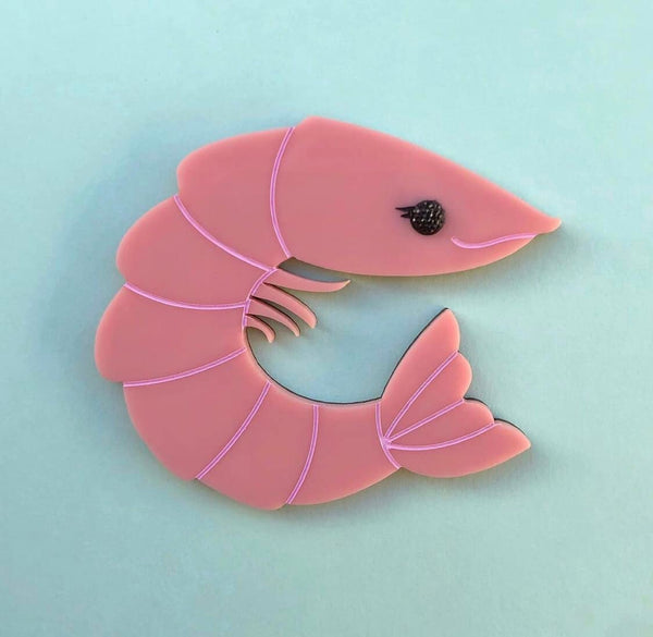 A pink prawn shrimp laser cut acrylic brooch designed by Louisa Camille for Peppy Chapette.